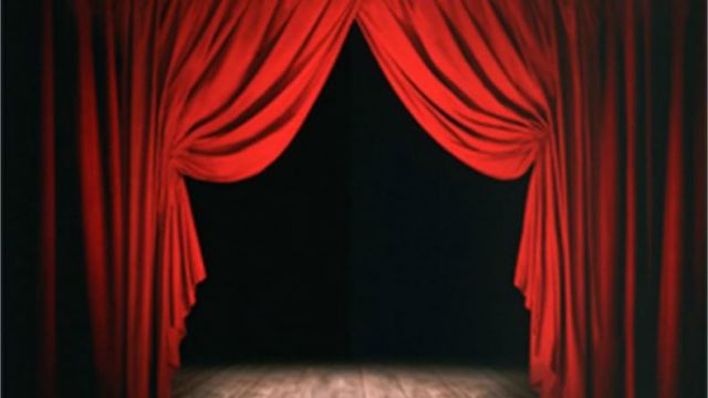 red stage curtains, open with black background